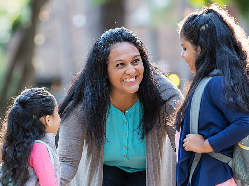smiling woman with two young girls