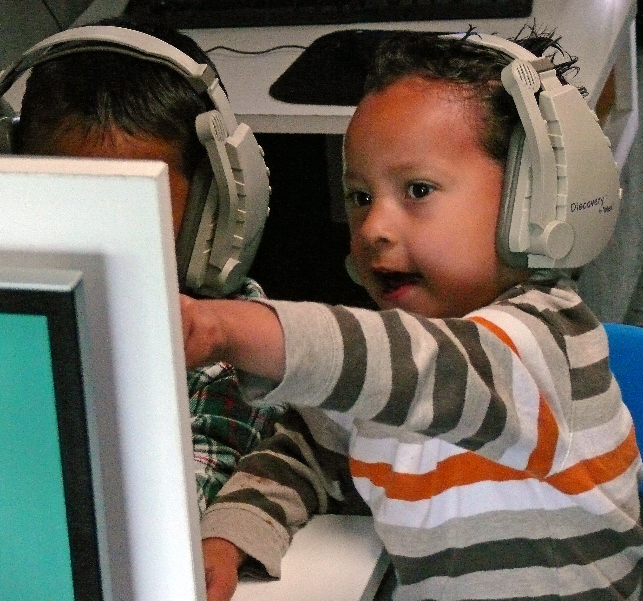 Mobile Waterford: Boy with headphones pointing at computer screen