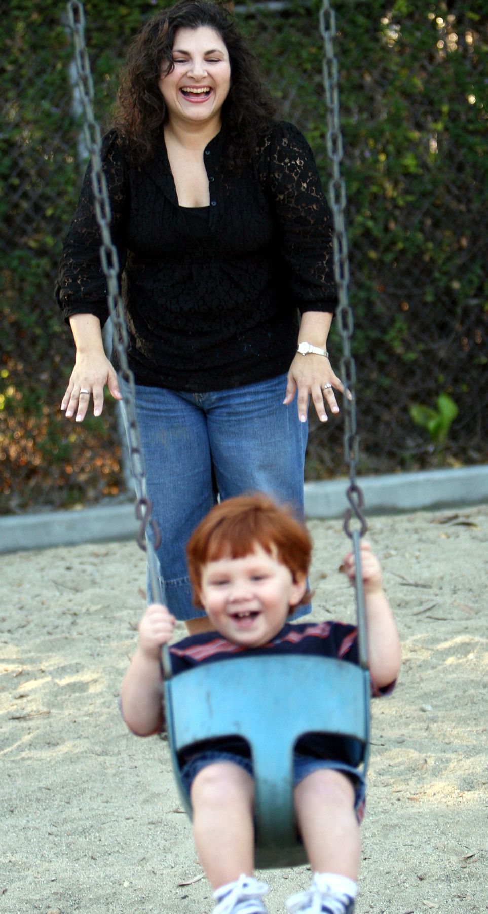 CASA Woman with child in playground swing