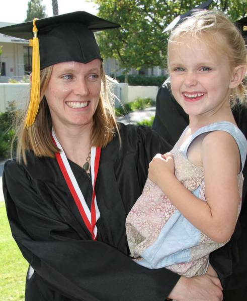 SBCC Single Parent Achievement Program: graduate with her daughter in her arms