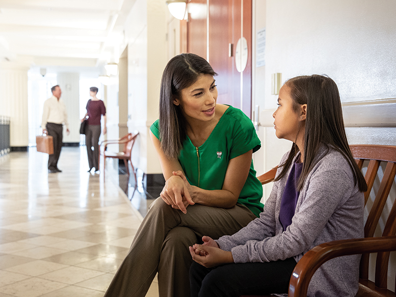 woman speaking with child outside courtroom