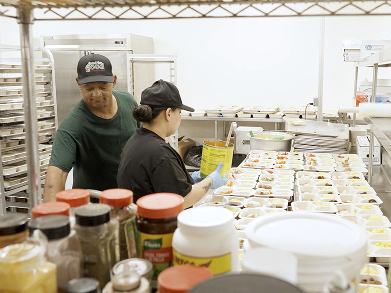 Two adults prepping food