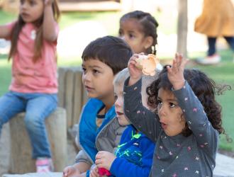 Smiling children participating in learning activity