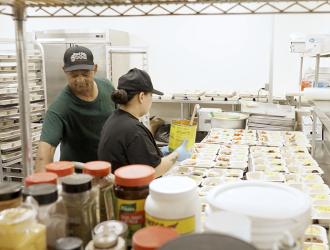Two adults prepping food