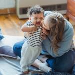 Mother kisses baby