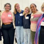 Six women from the Women's fund smile with linked arms