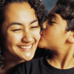 Young child kissing woman on the cheek