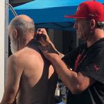 Man cuts another man's hair