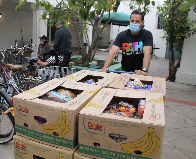 PATH staff member pushing food cart